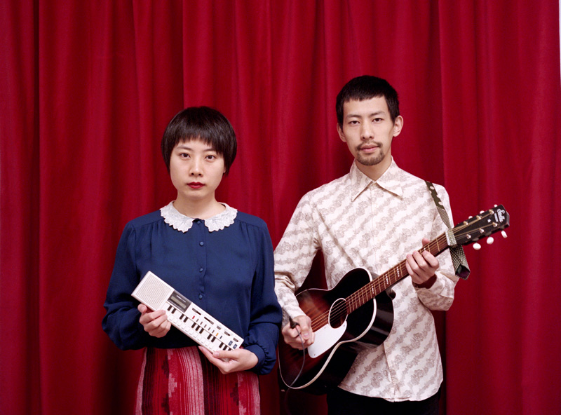  pimo-standing-in-front-of-red-curtain 